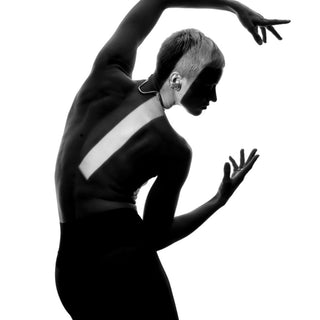 woman wearing necklace dancing light shadows 